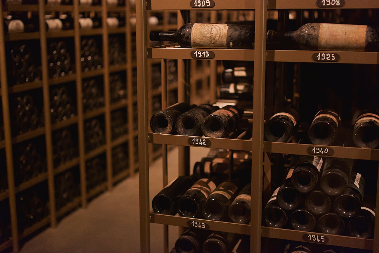 Explore a vintage wine cellar in Pauillac filled with historic wine bottles.