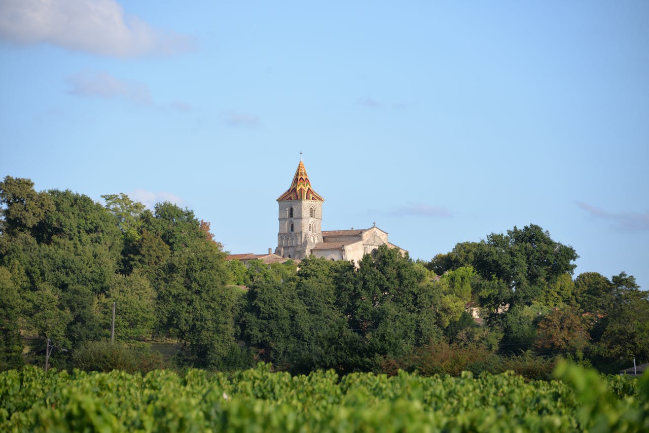 Stunning view of a traditional church surrounded by vineyards in Nouvelle-Aquitaine, France.